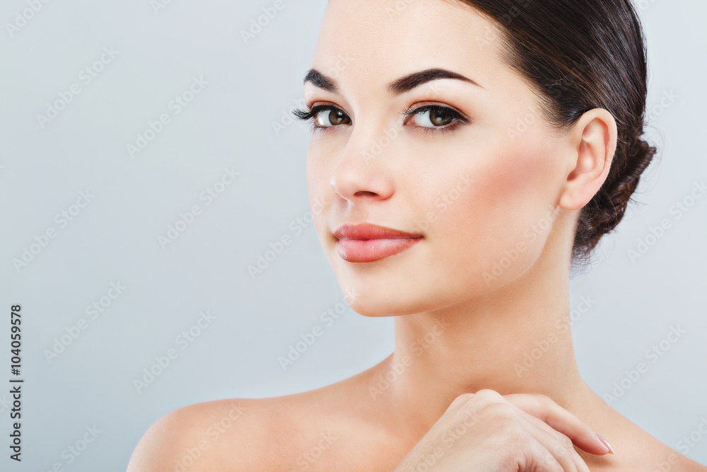 Pretty girl with dark hair at gray studio background Pretty girl with dark hair at gray studio background