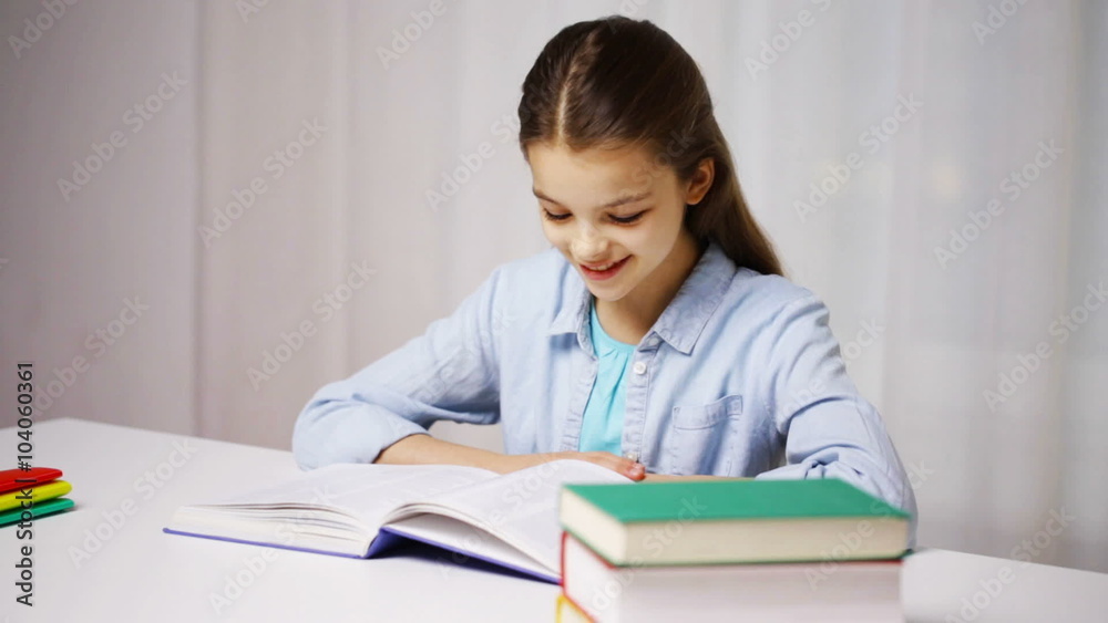happy school girl reading book or textbook at home happy school girl reading book or textbook at home