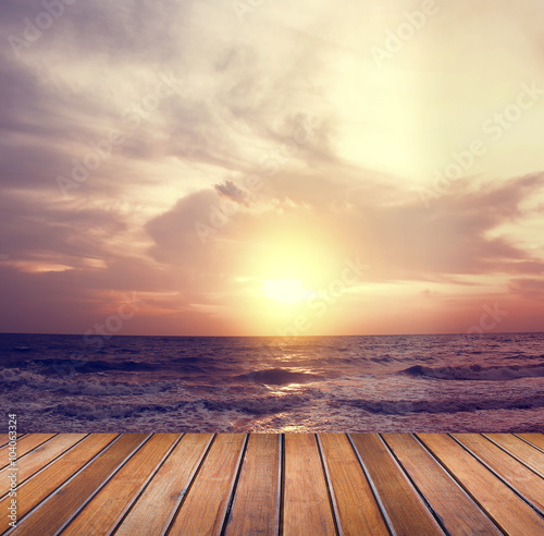 Over sea setting sun with wooden floor  © memorystockphoto