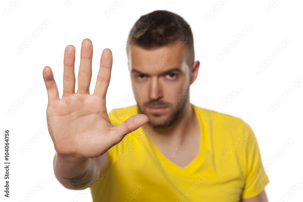 handsome young man showing stop hand handsome young man showing stop hand