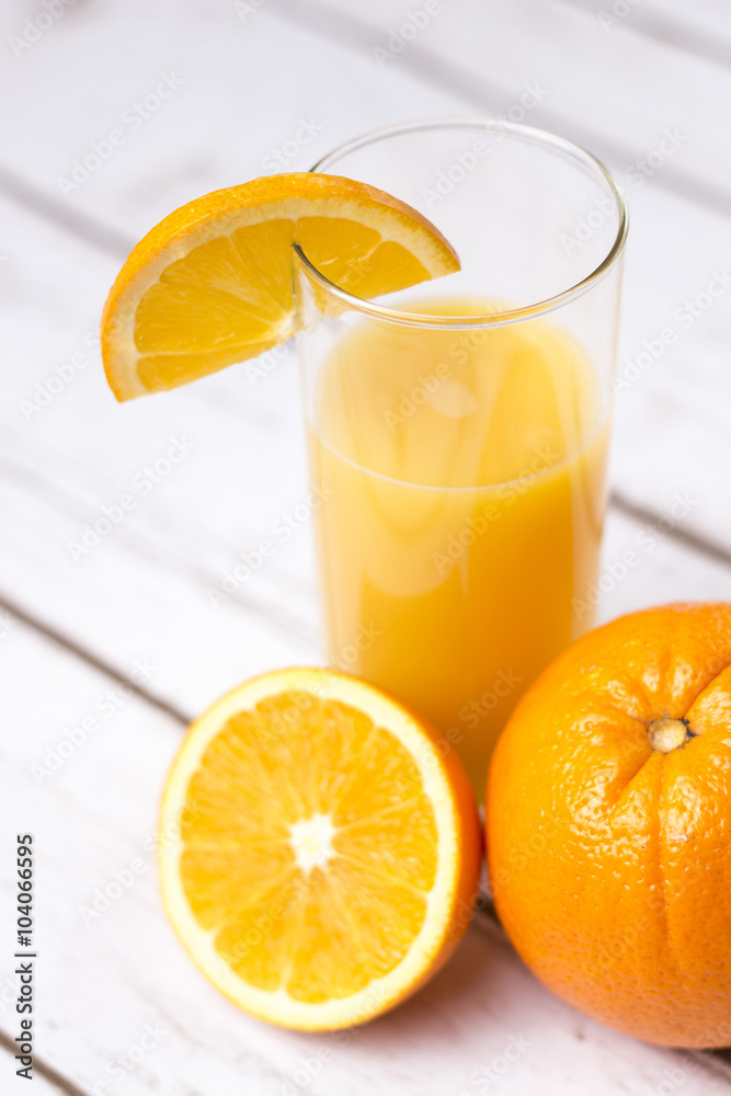 Fresh orange juice in glass with sliced orange Fresh orange juice in glass with sliced orange