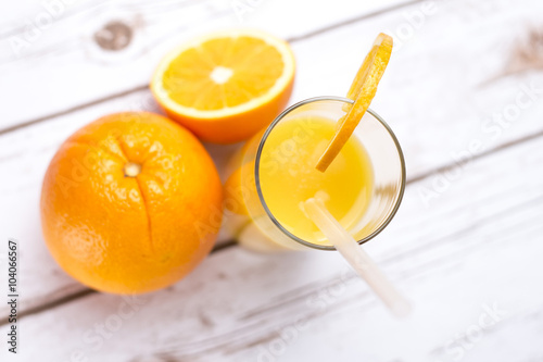 Fresh orange juice in glass with sliced orange