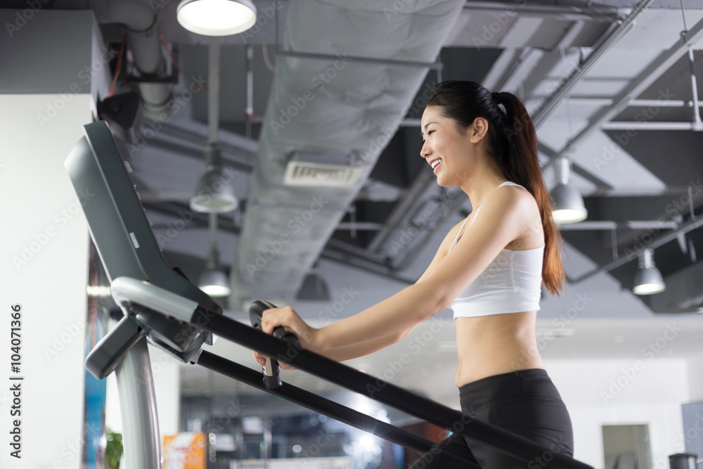 Fototapeta premium beautiful girl working out in modern gym