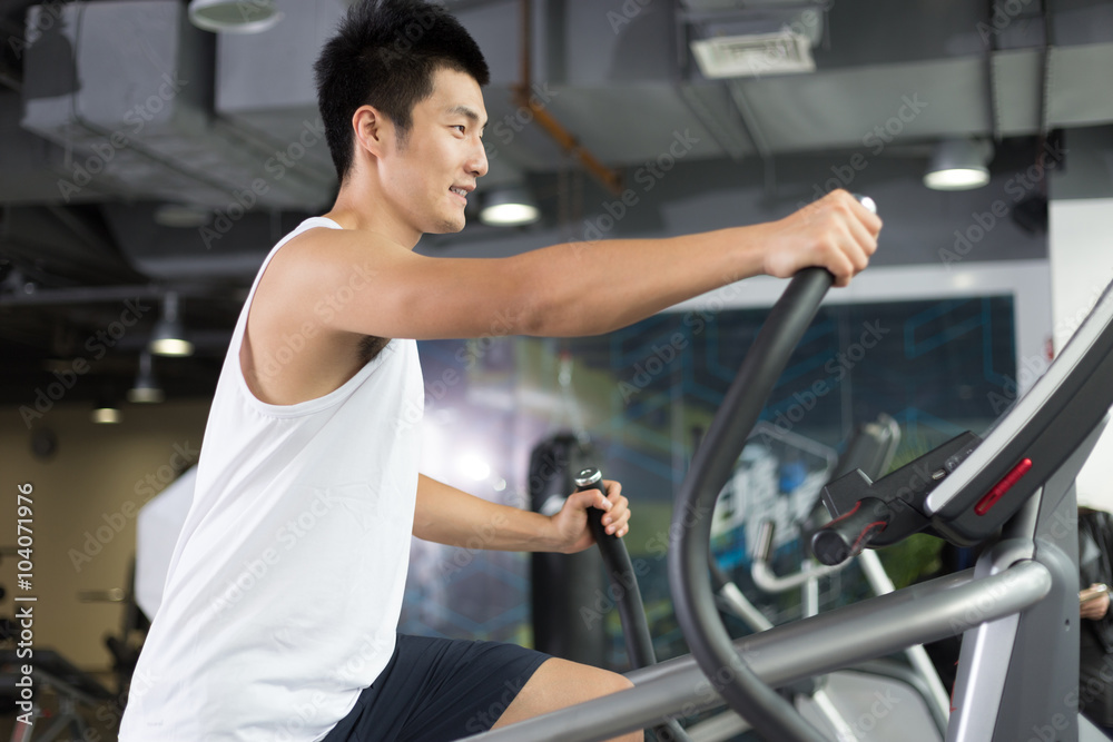 young man working out in modern gym young man working out in modern gym