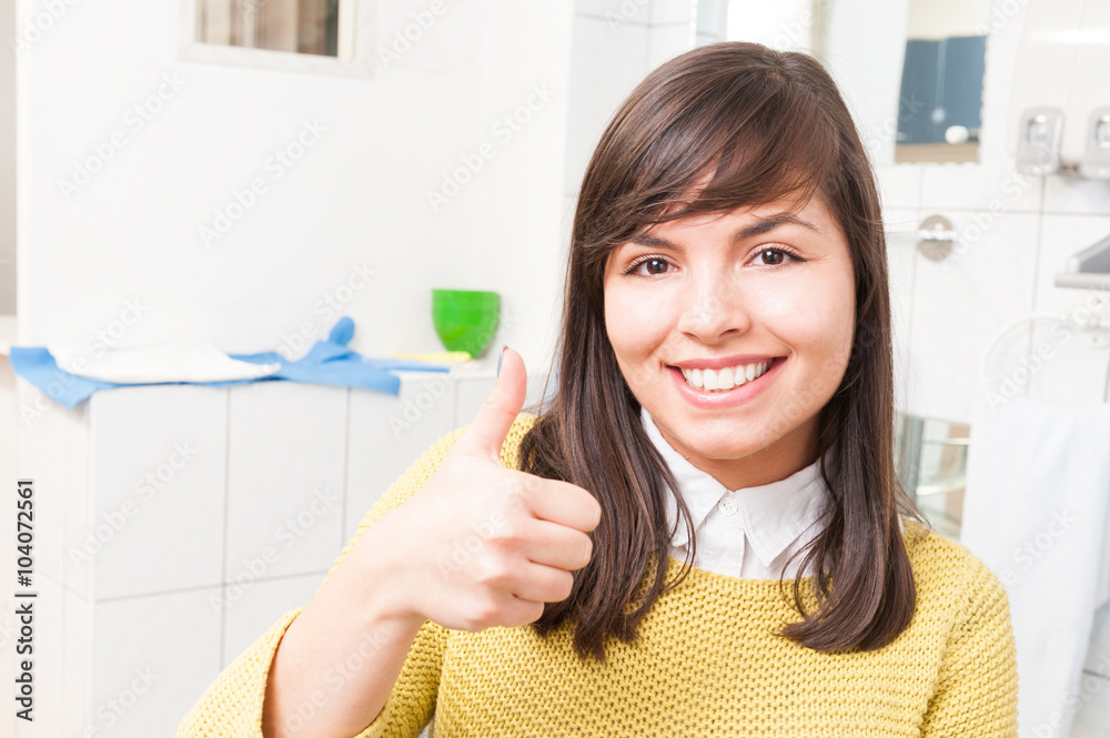 Beautiful young patient thumb up at the dental clinic Beautiful young patient thumb up at the dental clinic
