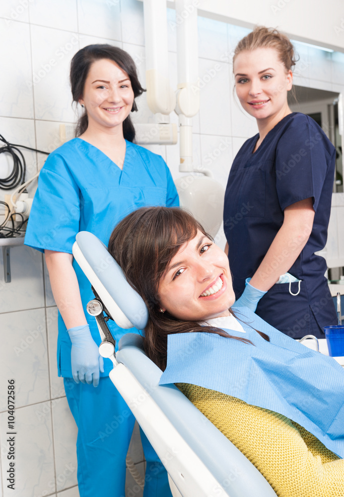 Dental clinic with female dentist, assistant and patient Dental clinic with female dentist, assistant and patient