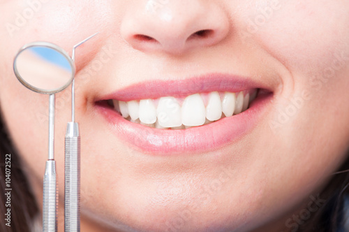 Close up of woman perfect smile with dental equipment