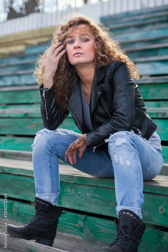 Beautiful girl sitting on tribune Beautiful girl sitting on tribune