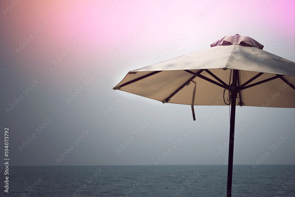 Umbrella on beach, sun, sea and sand vintage / White umbrella on beach, sun, sea on vintage background in summer