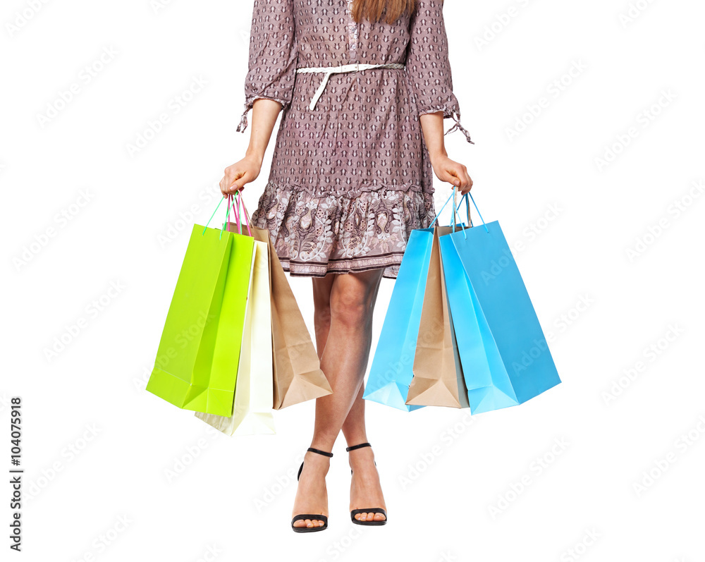 Midsection of beautiful woman with shopping bags isolated on whi