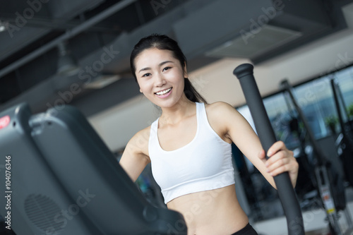 beautiful girl working out in modern gym