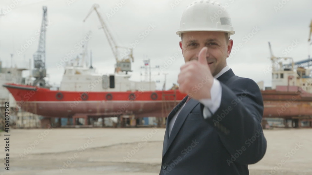 Successful businessman in a suit on the seaport Successful businessman in a suit on the seaport