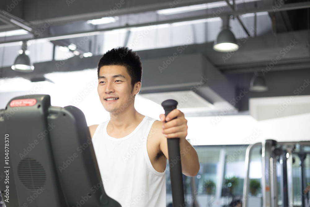 young man working out in modern gym young man working out in modern gym