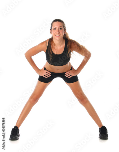 Happy young woman holding doing exercise and stretching over white