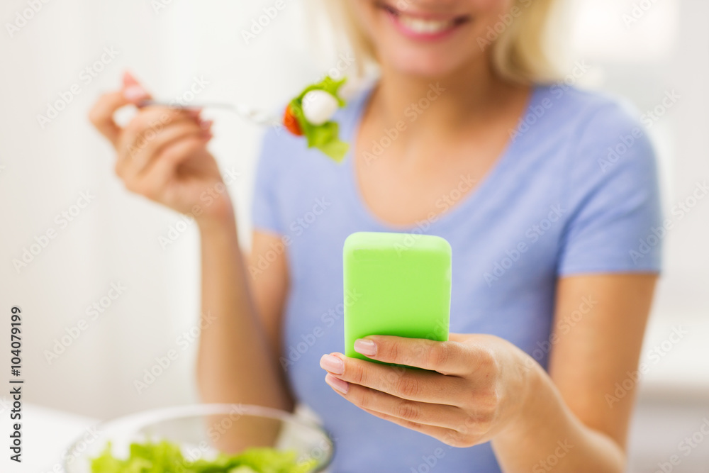 close up of woman with smartphone eating salad close up of woman with smartphone eating salad