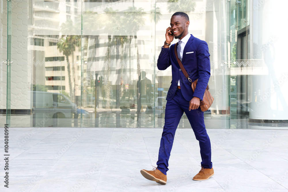 © mimagephotos - Confident young businessman using cell phone in city © mimagephotos - Confident young businessman using cell phone in city