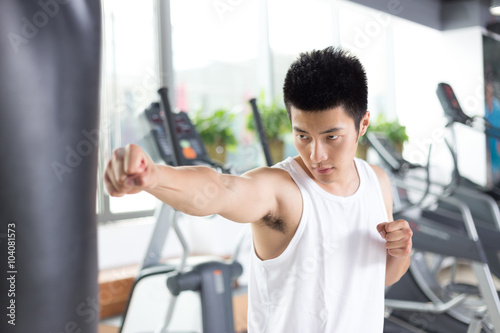 young man working out in modern gym © zhu difeng