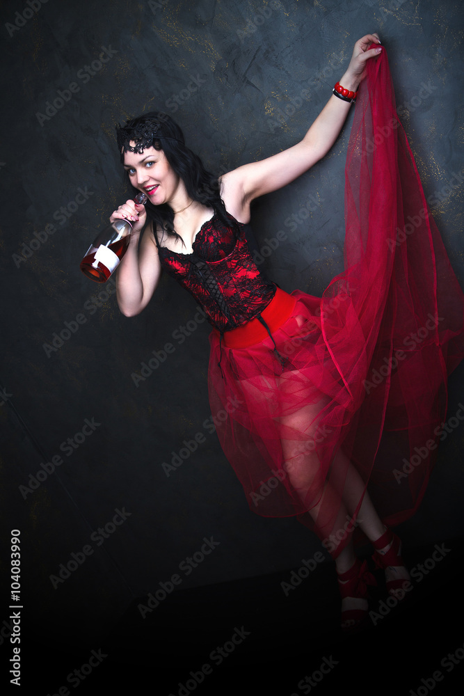 Fototapeta Happy Beautiful brunette woman in corset and long hair with bottle of wine