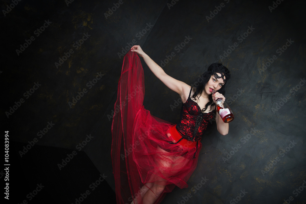 Fototapeta Happy Beautiful brunette woman in corset and long hair with bottle of wine