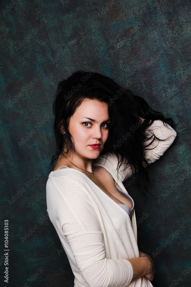 Studio portrait of a sexy brunette in grey lingerie and white cardigan Studio portrait of a sexy brunette in grey lingerie and white cardigan