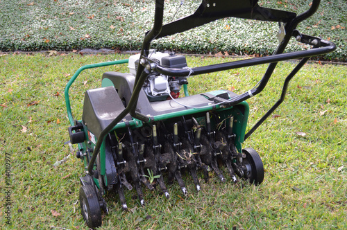 Lawn aeration machine with grass plug stuck in the stem photo