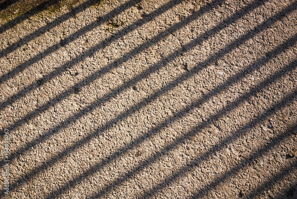 A photograph of railing shadows cast on the floor A photograph of railing shadows cast on the floor