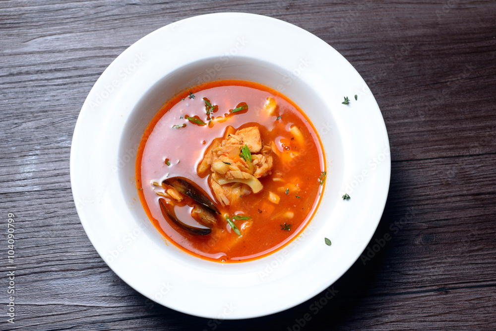 Delicious soup with mussels on black background Delicious soup with mussels on black background