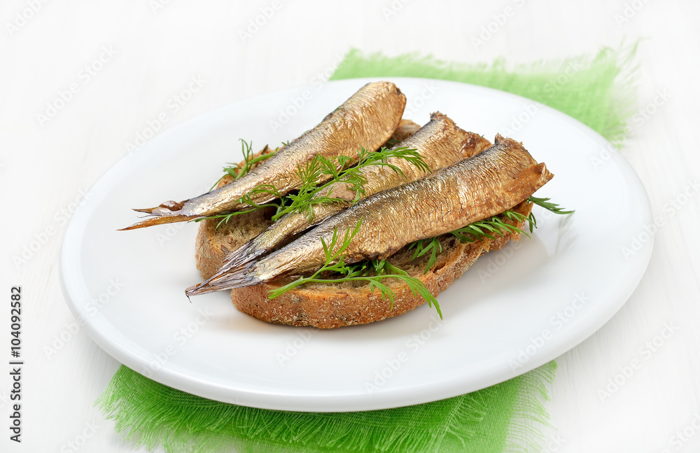 Sprats sandwiches on white plate Sprats sandwiches on white plate