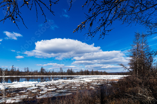 Spring day landscape with river, forest and clouds on the blue sky  photo