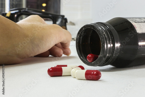 Overdose drug addict hand, drugs narcotic syringe on floor photo