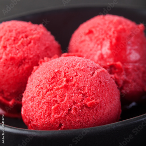 Ice cream cherry, raspberry, strawberry, cranberry , red sorbet Black slate background
