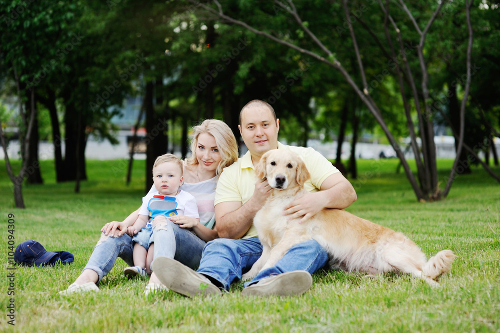 family plays with the retriever in the grass family plays with the retriever in the grass