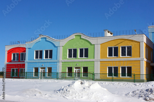 Modern colorful houses against a blue sky in the winter