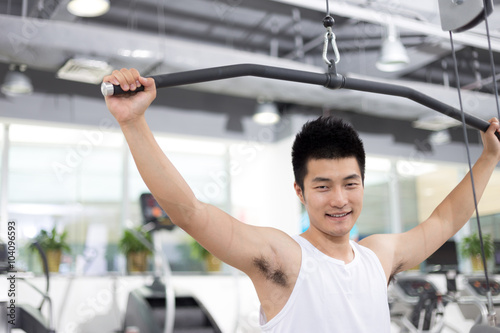 young man working out in modern gym