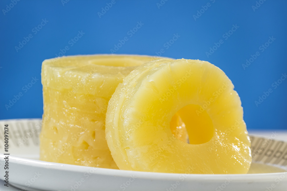 Canned pineapple slices, preserved at its own juice, on oval dish Canned pineapple slices, preserved at its own juice, on oval dish