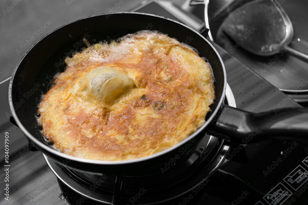 Deep frying egg omelette isolated in Black and White Background. Deep frying egg omelette isolated in Black and White Background.
