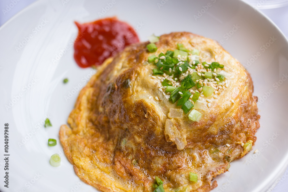 fried egg omelette with scallion and white sesame ready to serve on dish. fried egg omelette with scallion and white sesame ready to serve on dish.