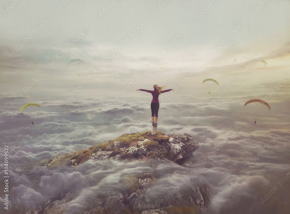 Young woman in the sky standing on a rock with divorced hands Young woman in the sky standing on a rock with divorced hands
