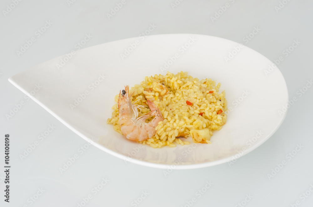 Paella, typical Spanish dish on white background.