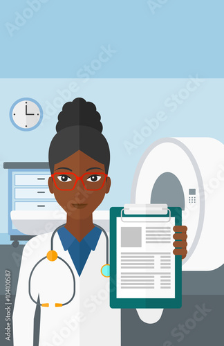 Doctor in hospital room with MRI machine.