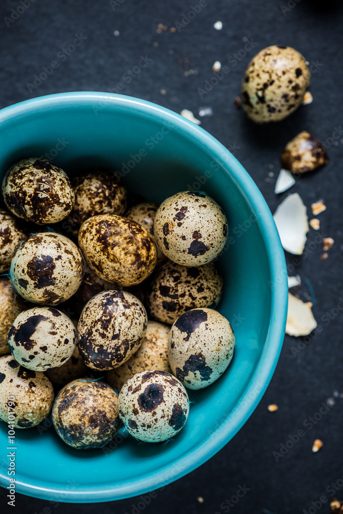Quail eggs in pastel bowl on dark background, Easter concept. Quail eggs in pastel bowl on dark background, Easter concept.