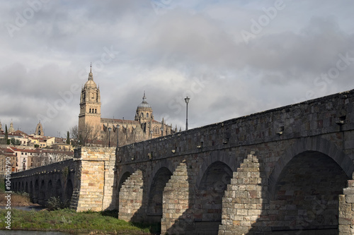 Stone bridge which was built by the Romans. Fabulous views of the medieval cathedral. Catedral Nueva de Salamanca. Spain. photo