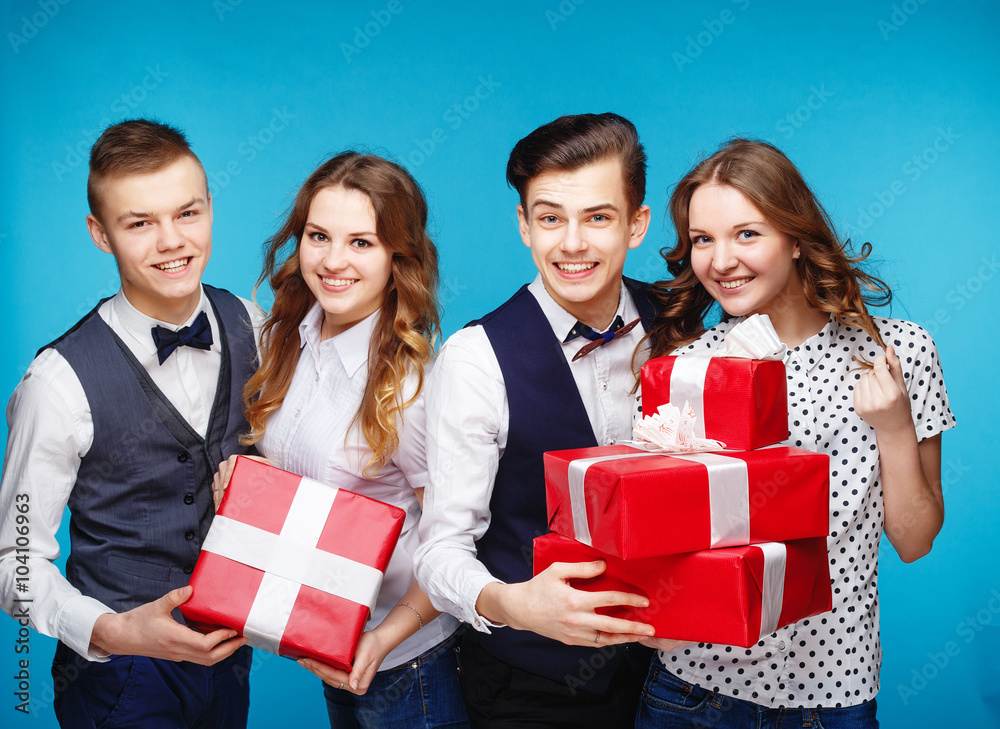 Smiling hipster group with the gifts in the studio Smiling hipster group with the gifts in the studio