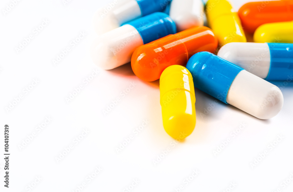 Various cold prescription bottles and a syringe isolated on a wh Various cold prescription bottles and a syringe isolated on a wh