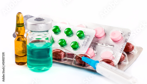 Medications tablets and capsules in a beaker