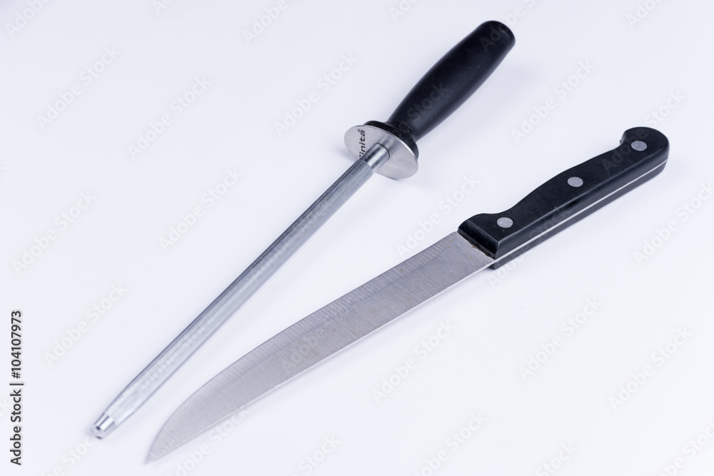 Kitchen knife and shrapening tool over white background Kitchen knife and shrapening tool over white background