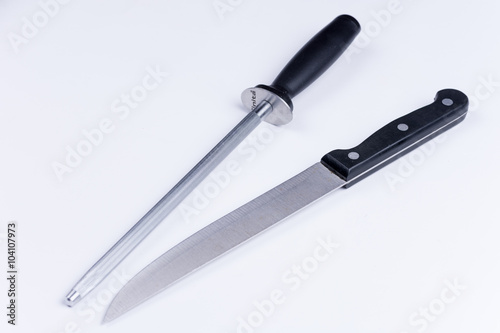 Kitchen knife and shrapening tool over white background