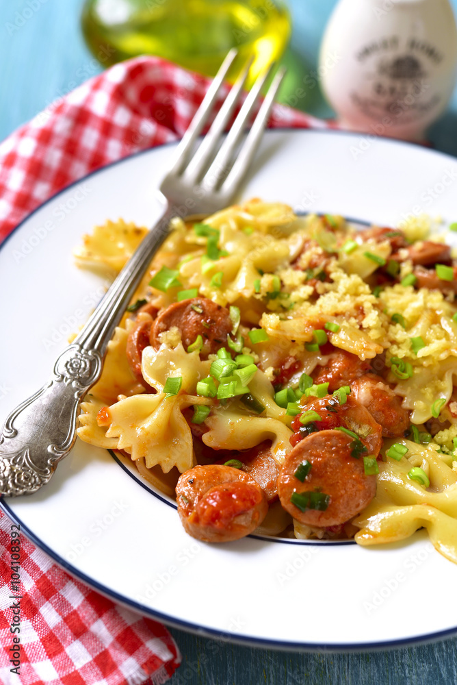 Farfalle with sausage in tomato sauce.