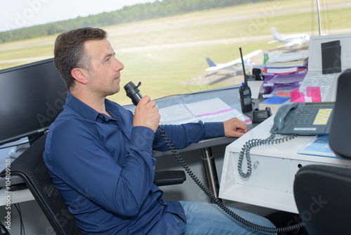 Man communicating from airport control tower