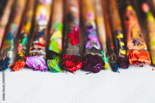 Artist paintbrushes closeup on artistic canvas. Selective focus.